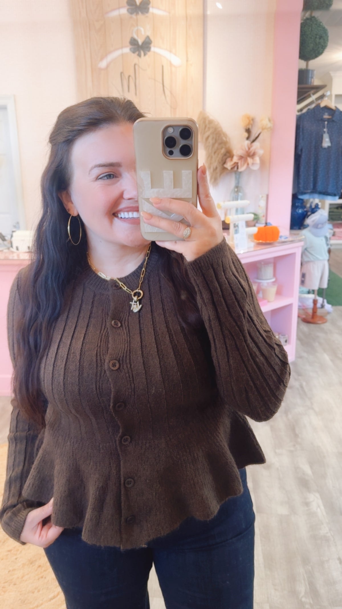 Model wearing the Off Duty brown ribbed button-front peplum cardigan with jeans.