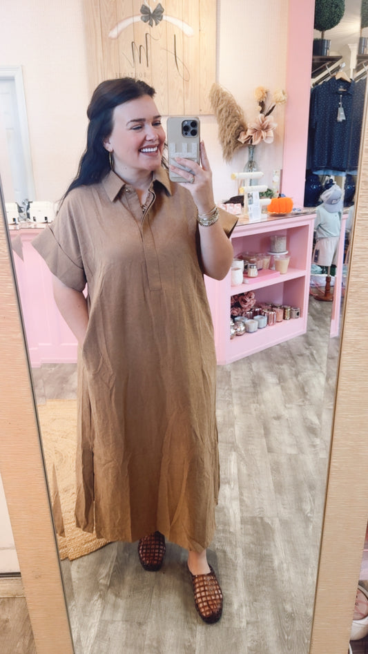 Model wearing the camel short-sleeve collared midi dress with side pockets.