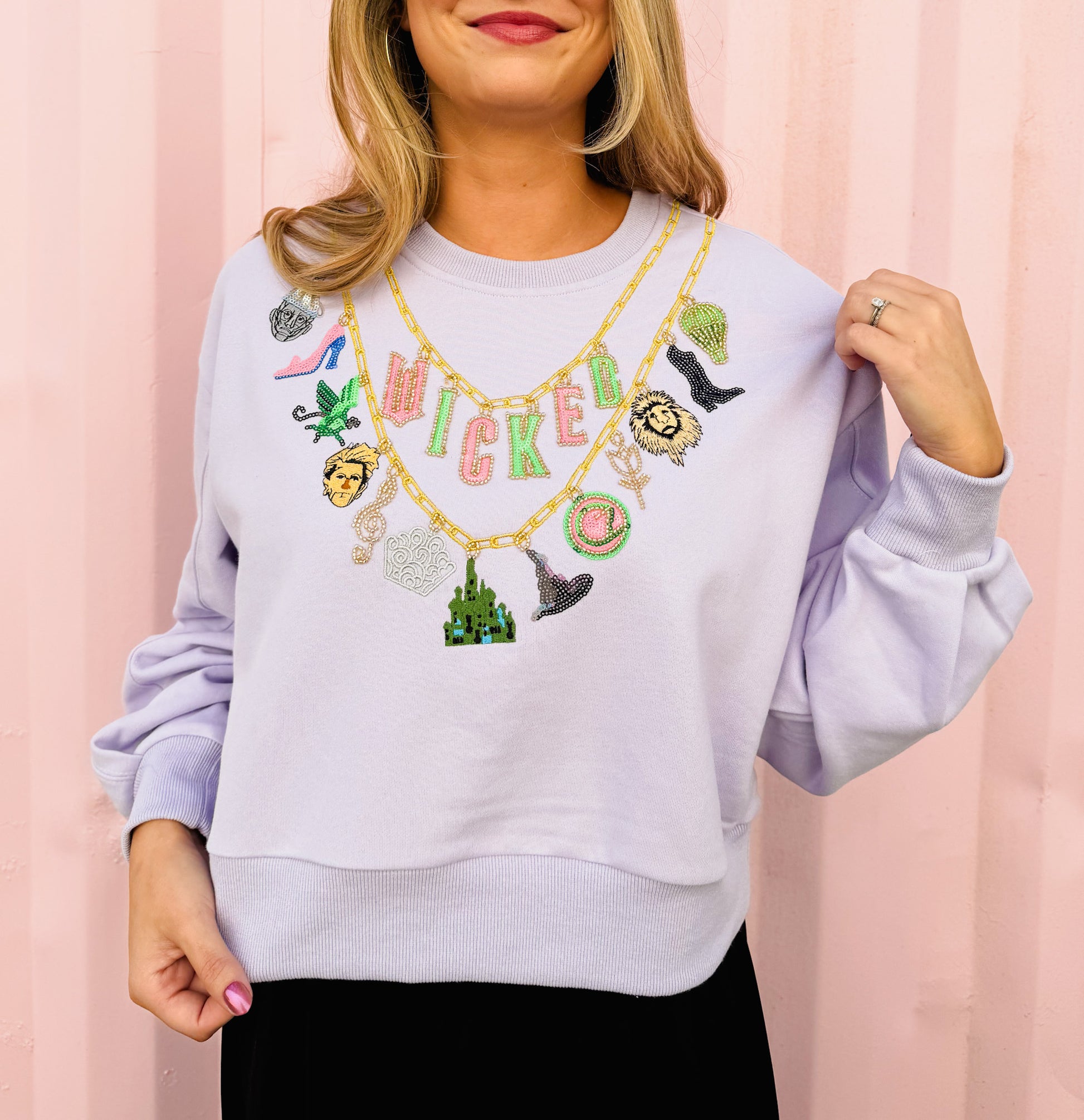 Licensed Wicked x Queen Of Sparkles Lavender Wicked Charm Necklace Sweatshirt